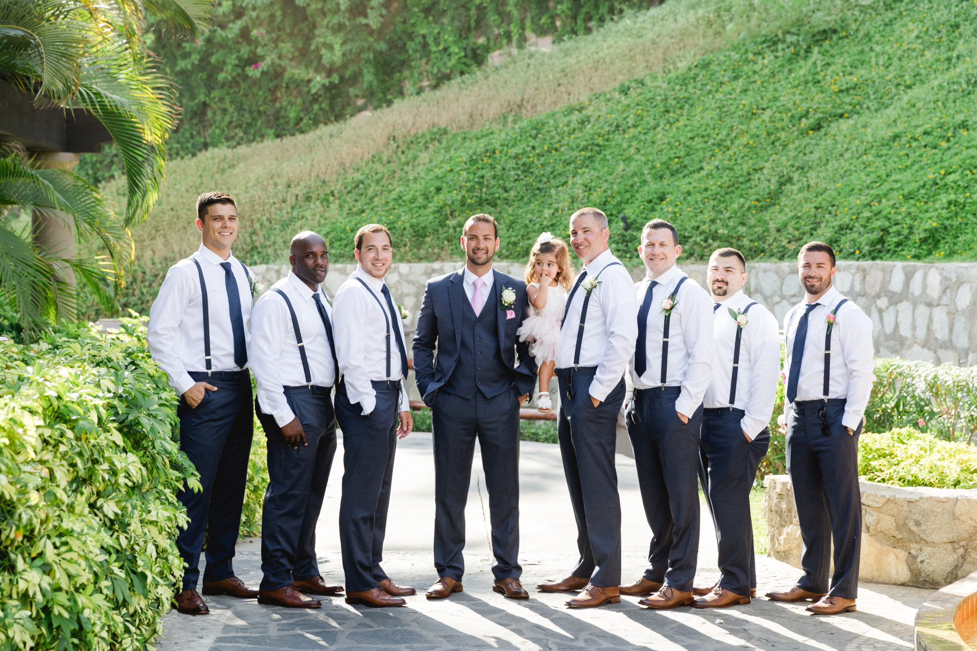 Groomsmen wearing tailor-made suits at a wedding